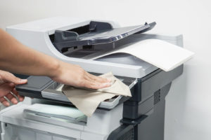 Photocopier being cleaned